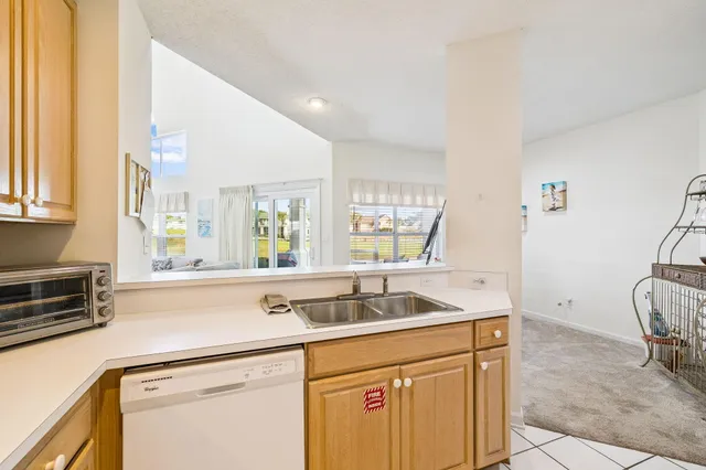 a kitchen with granite countertop a sink and a stove top oven