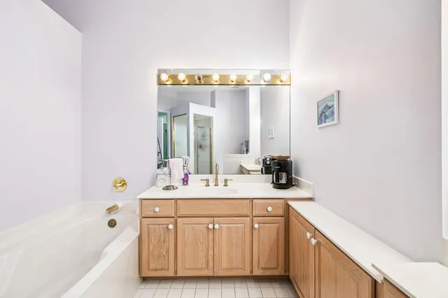 a bathroom with a sink a vanity and a bathtub