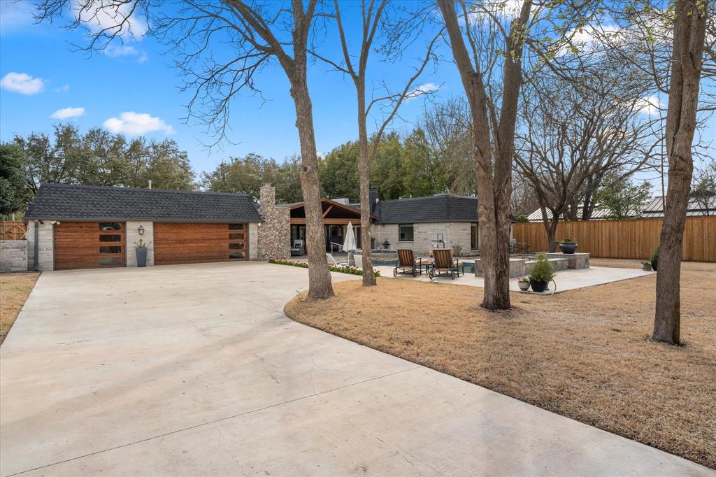 5505 Northaven Road Dallas, TX 75229 - Photo 14 of 40 View of front facade with a garage, an outbuilding, a chimney, and fence