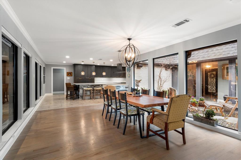5505 Northaven Road Dallas, TX 75229 - Photo 21 of 40 Dining room with visible vents, recessed lighting, crown molding, a notable chandelier, and light wood-type flooring