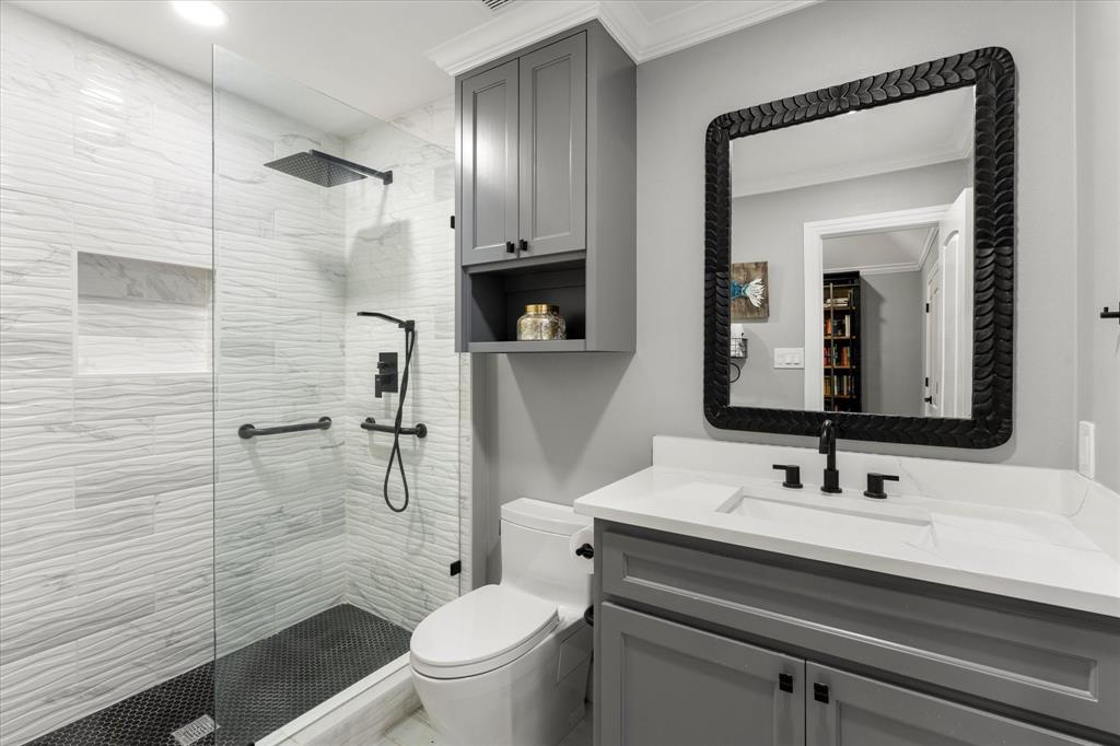 5505 Northaven Road Dallas, TX 75229 - Photo 35 of 40 Full bathroom with toilet, walk in shower, and ornamental molding