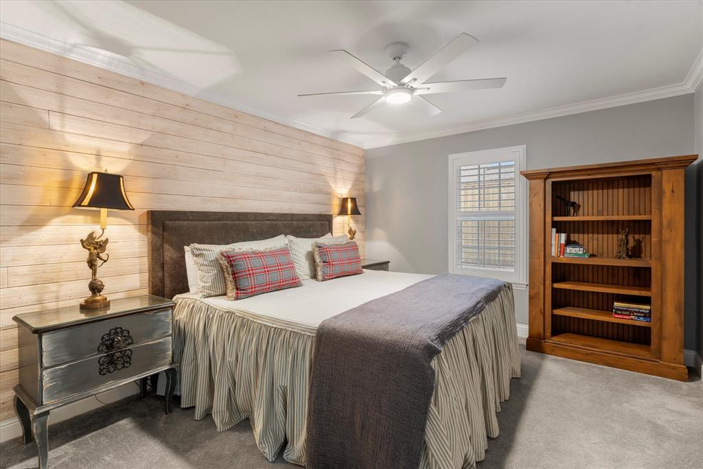 5505 Northaven Road Dallas, TX 75229 - Photo 40 of 40 Carpeted bedroom with crown molding, wood walls, and ceiling fan