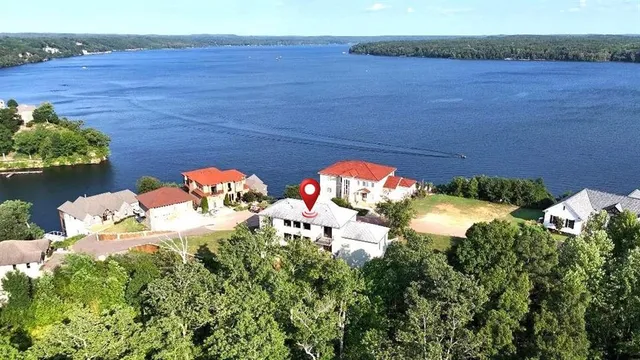 a view of a white house with a yard