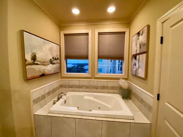 a bedroom with a bed and wall painting