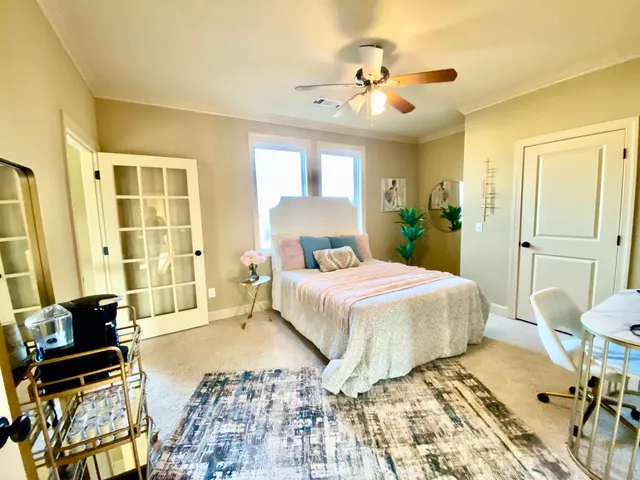 a bedroom with a bed and ceiling fan