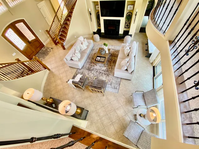 a living room with furniture and a chandelier