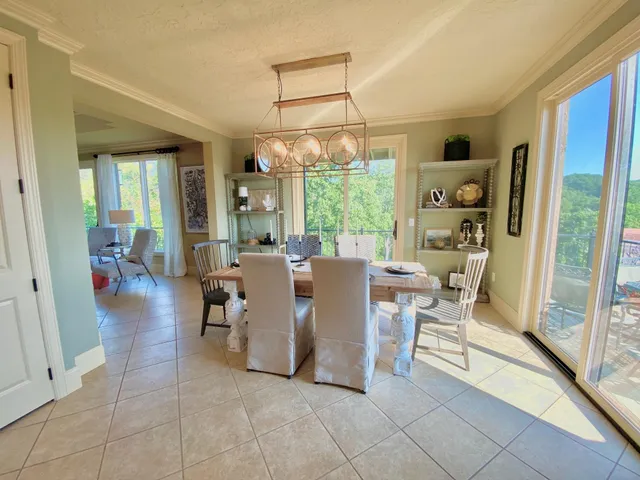a kitchen with stainless steel appliances kitchen island granite countertop a table and chairs in it