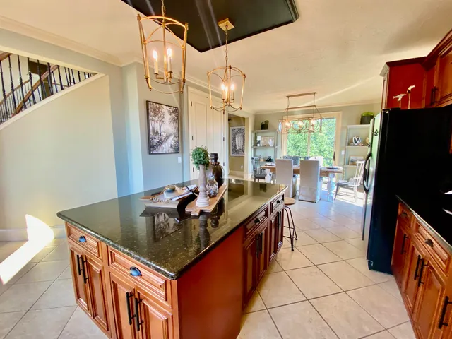 a dining room with furniture a chandelier and wooden floor