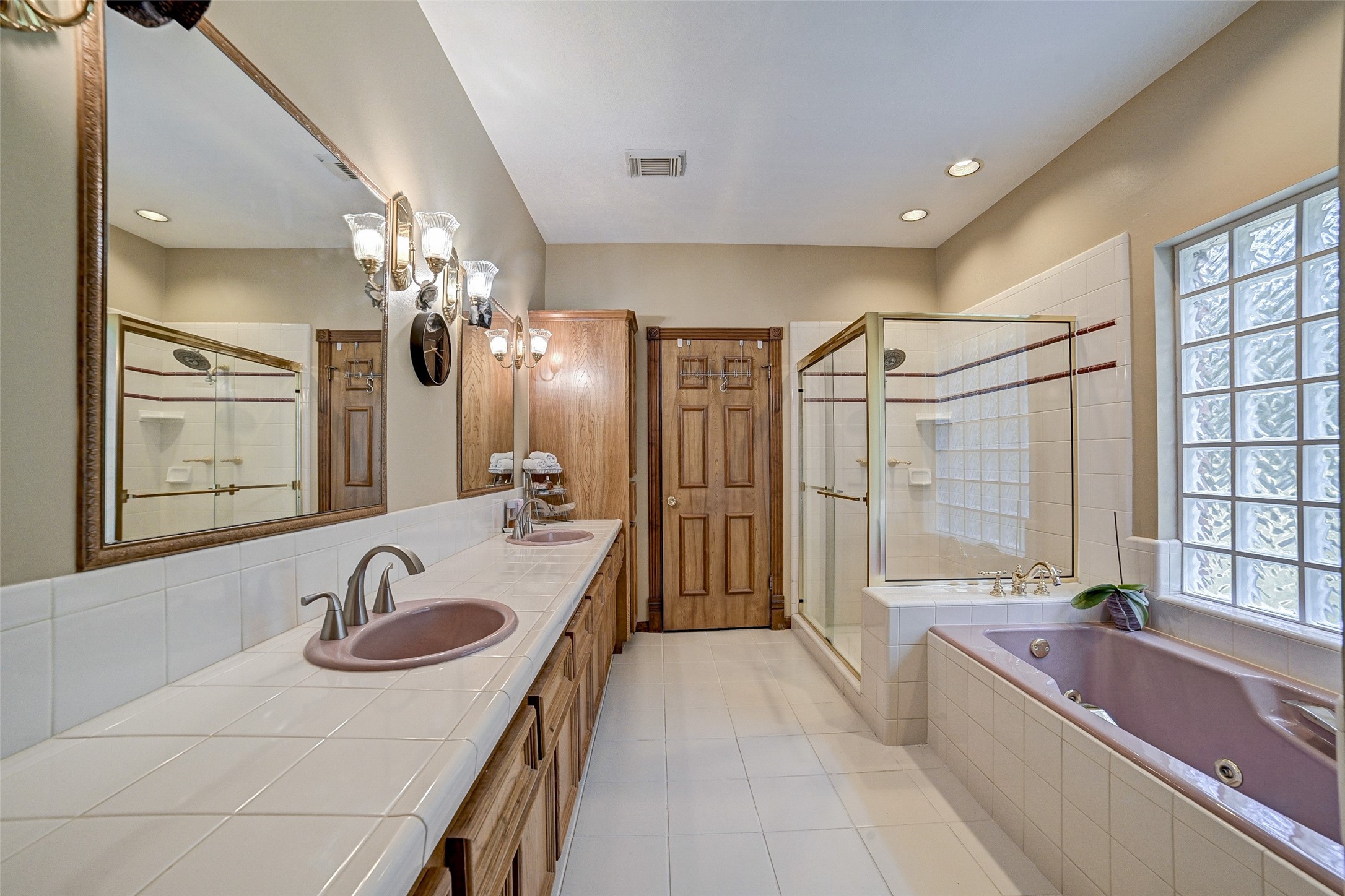 29803 Huffman Cleveland Road Huffman, TX 77336 - Photo 20 of 49 a en suite bathroom with a sink double vanity granite tub shower and mirror
