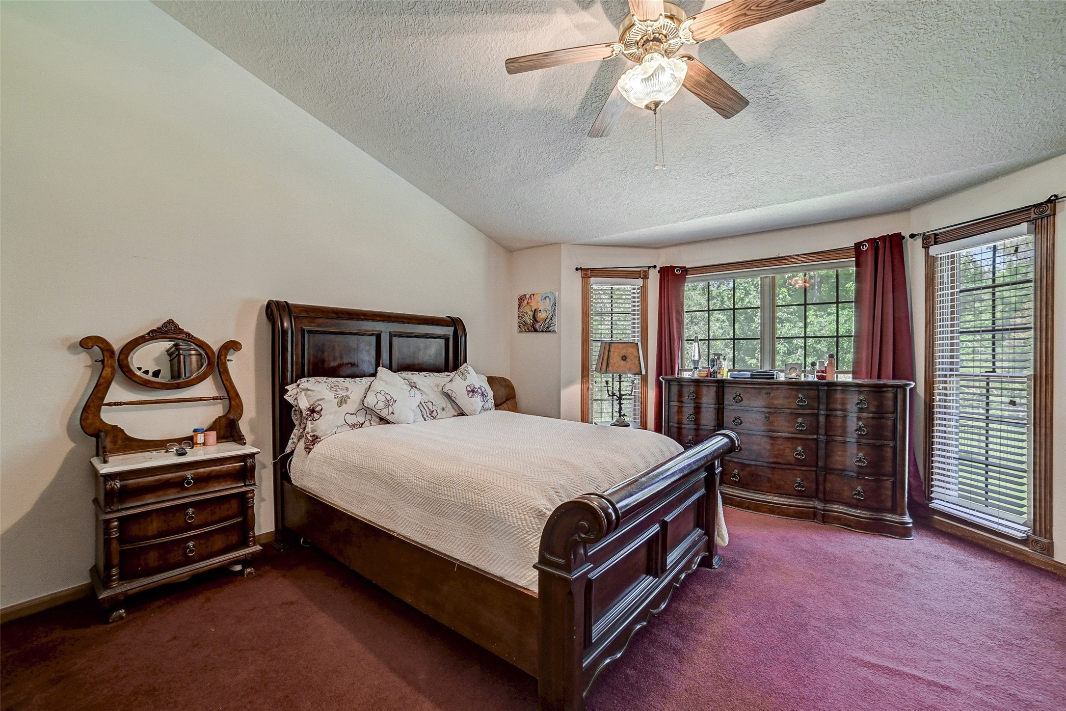 29803 Huffman Cleveland Road Huffman, TX 77336 - Photo 22 of 49 a bedroom with a bed and a chandelier