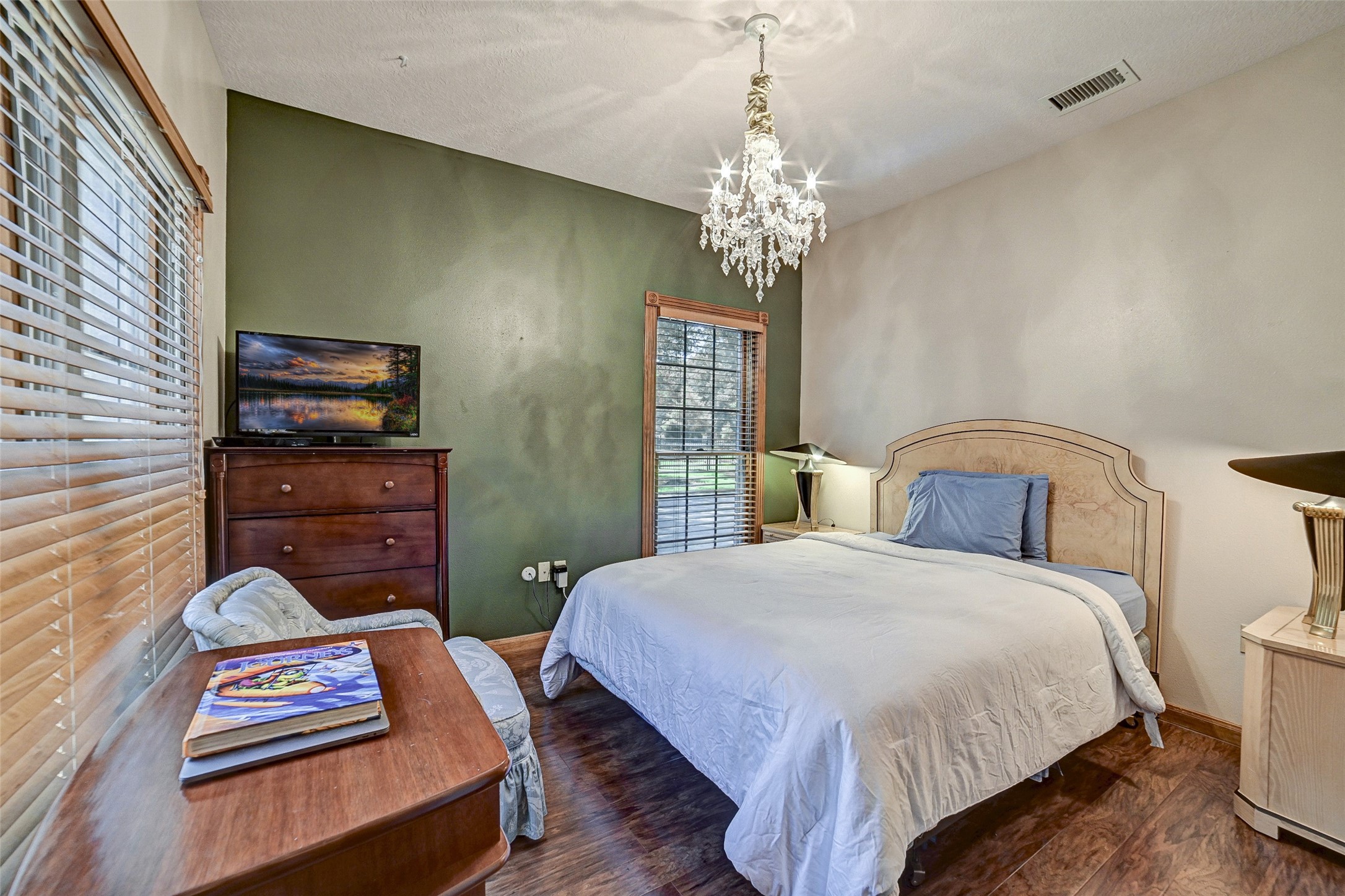 29803 Huffman Cleveland Road Huffman, TX 77336 - Photo 24 of 49 a bedroom with a bed dresser and a dining table