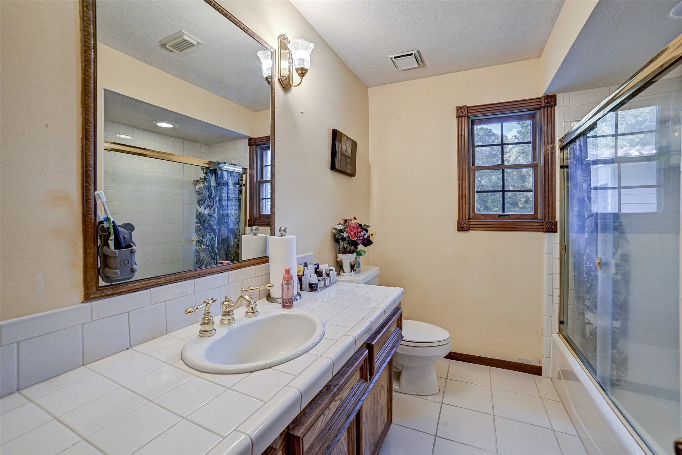 29803 Huffman Cleveland Road Huffman, TX 77336 - Photo 26 of 49 a bathroom with a sink vanity mirror and toilet