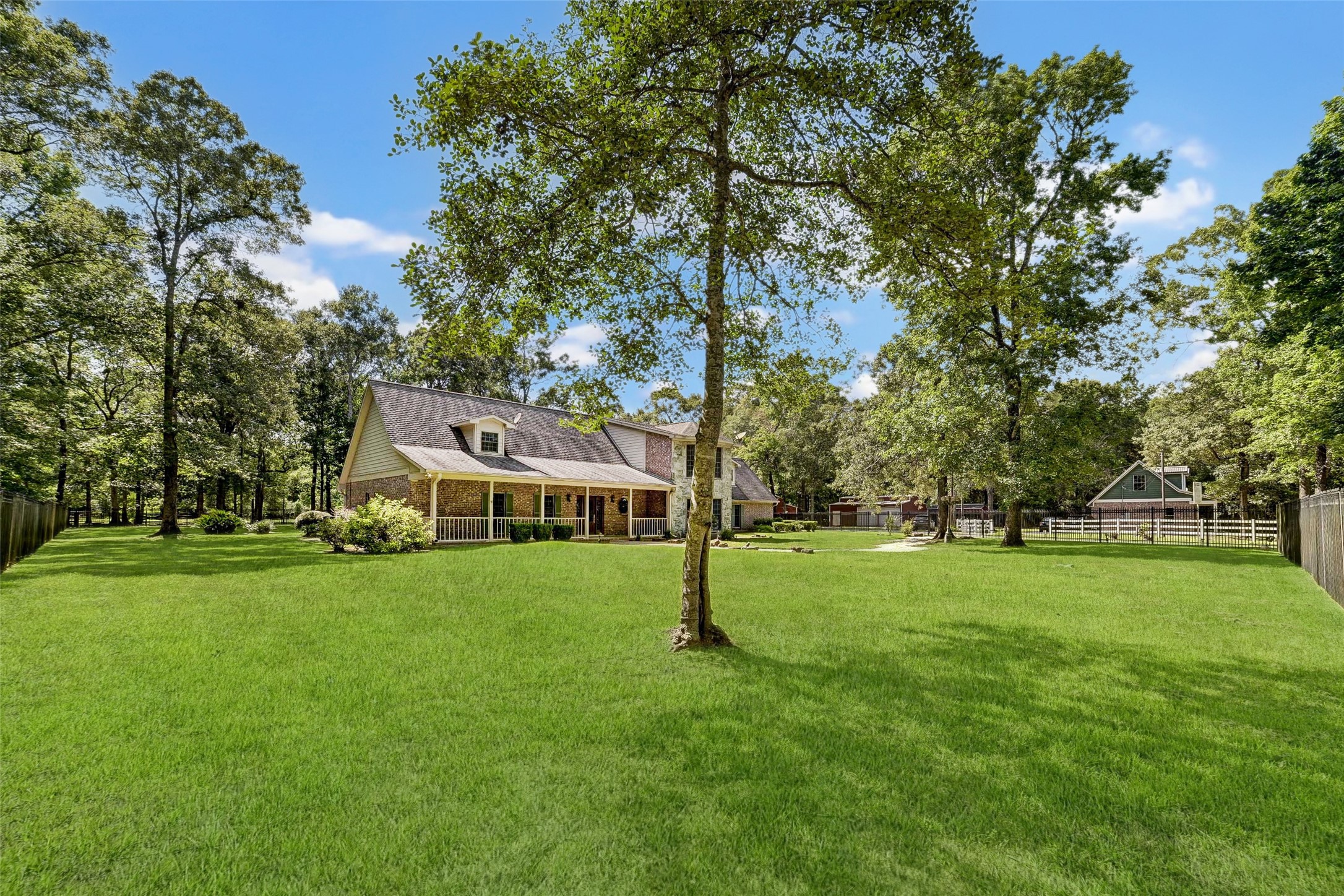 29803 Huffman Cleveland Road Huffman, TX 77336 - Photo 3 of 49 a view of a big yard with a house in the background