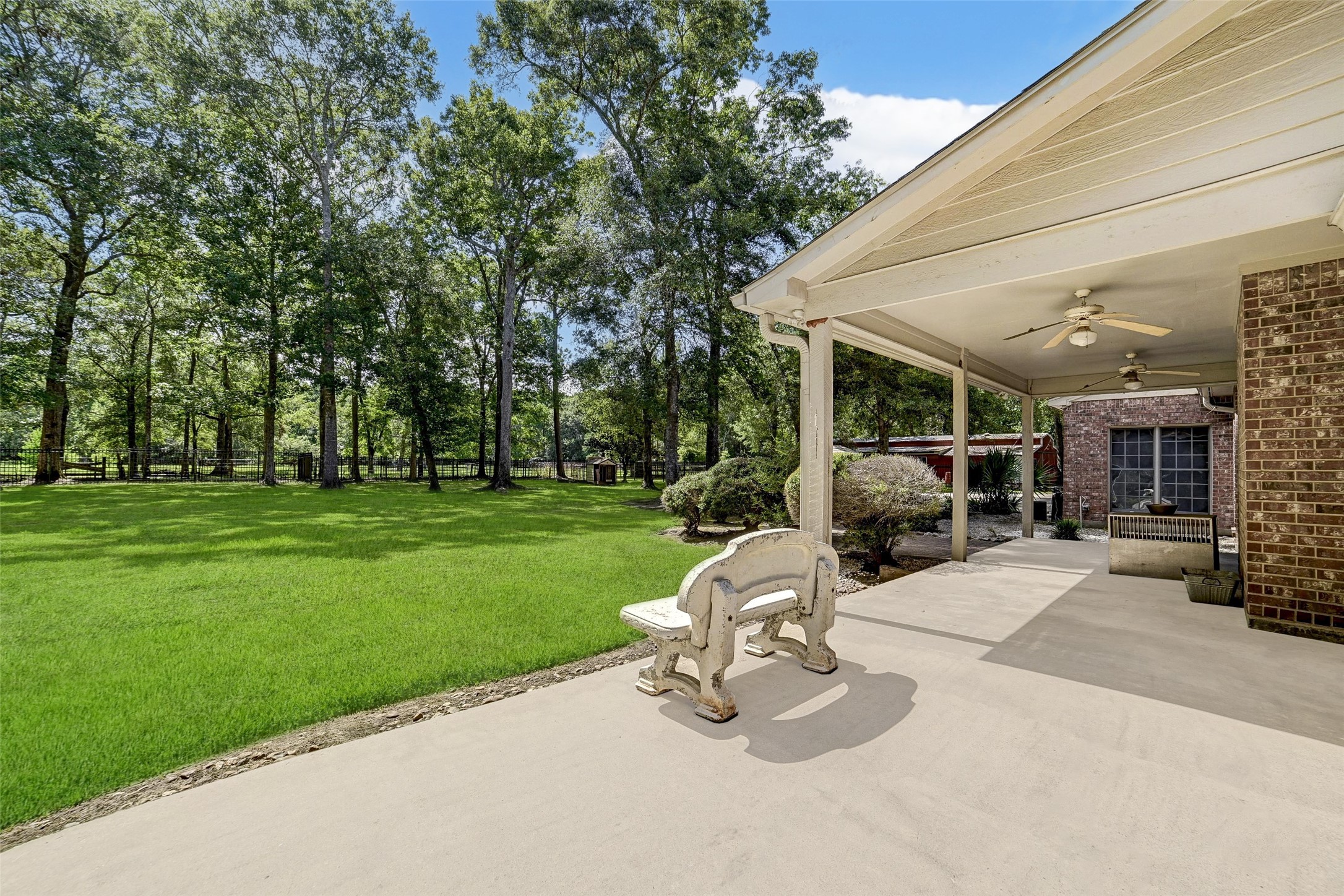 29803 Huffman Cleveland Road Huffman, TX 77336 - Photo 31 of 49 a view of a backyard with table and chairs and a fire pit