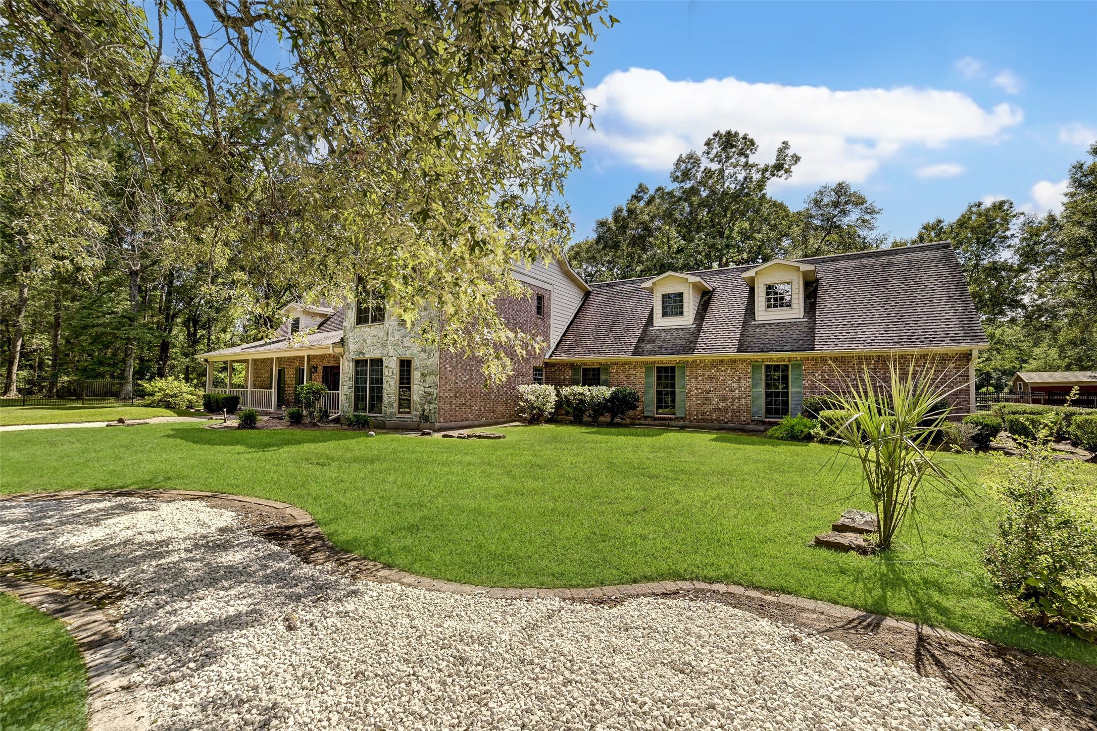 29803 Huffman Cleveland Road Huffman, TX 77336 - Photo 33 of 49 a front view of a house with a garden