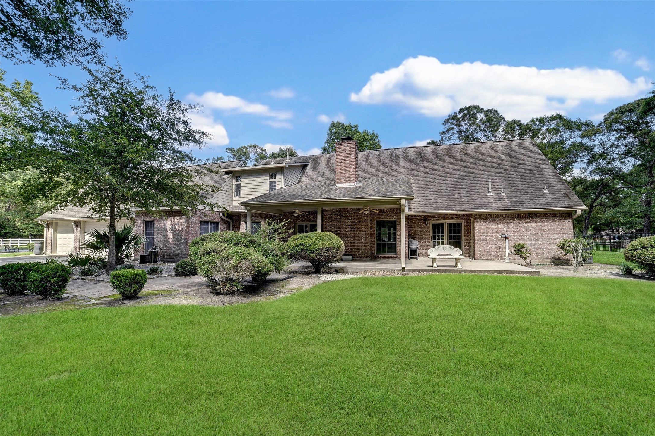 29803 Huffman Cleveland Road Huffman, TX 77336 - Photo 34 of 49 a view of a house with a garden and deck