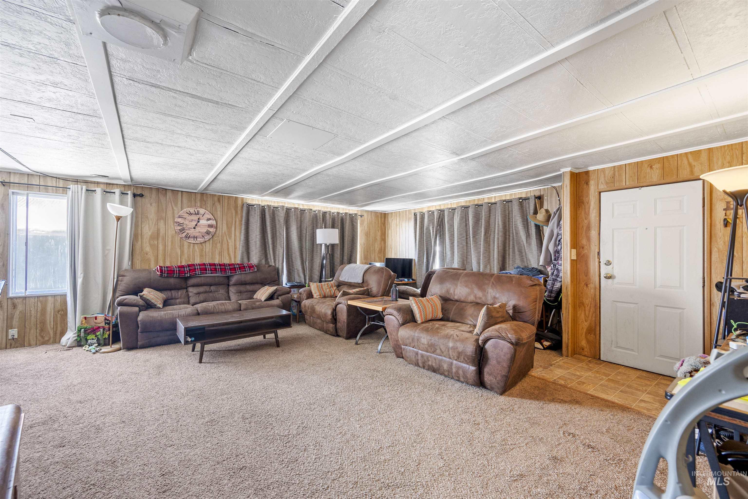 2382 East Syringa Street Eagle, ID 83616 - Photo 16 of 25 Living area with wood walls and carpet floors