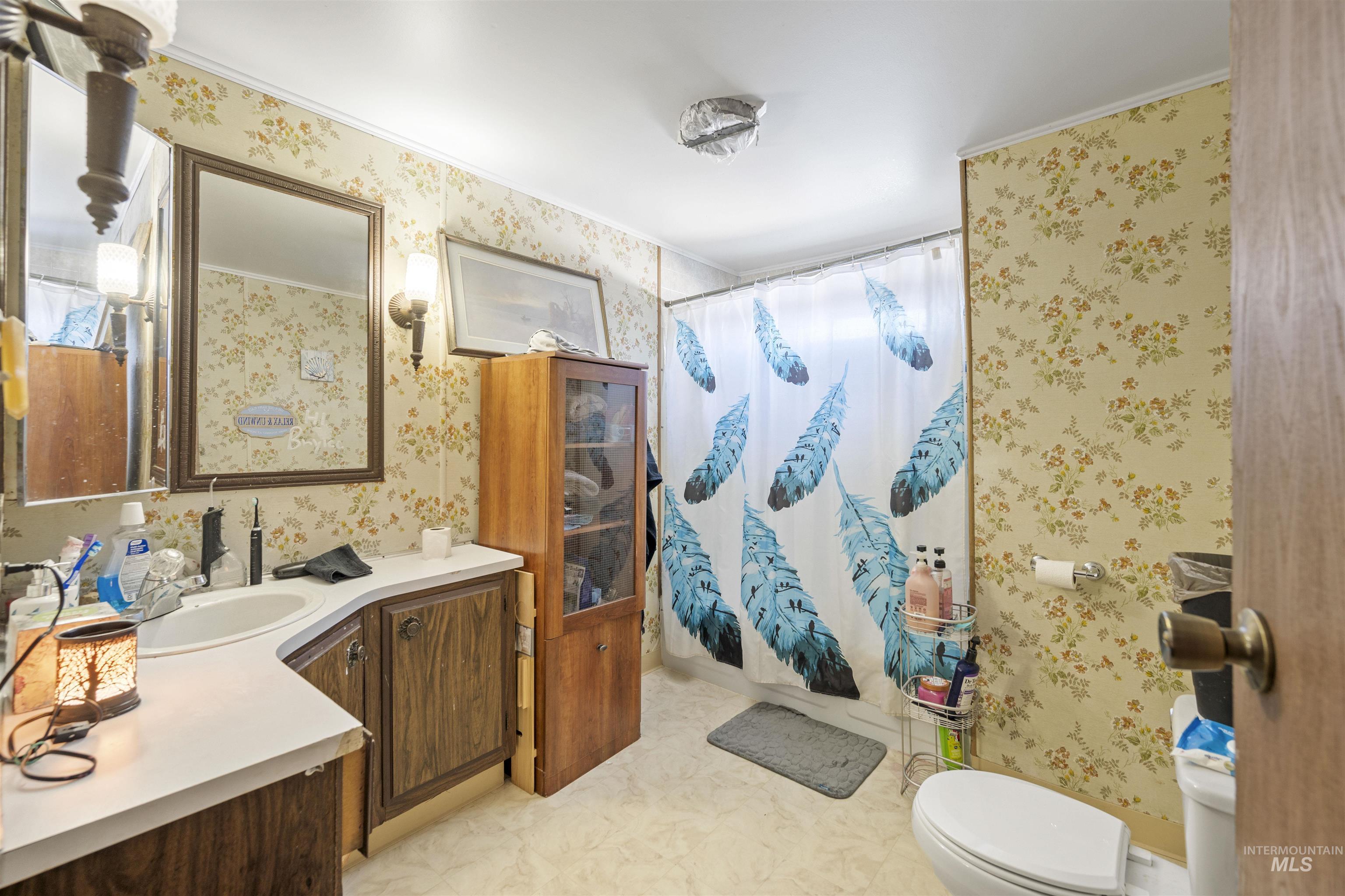 2382 East Syringa Street Eagle, ID 83616 - Photo 25 of 25 Full bath with wallpapered walls, vanity, a shower with curtain, and light floors