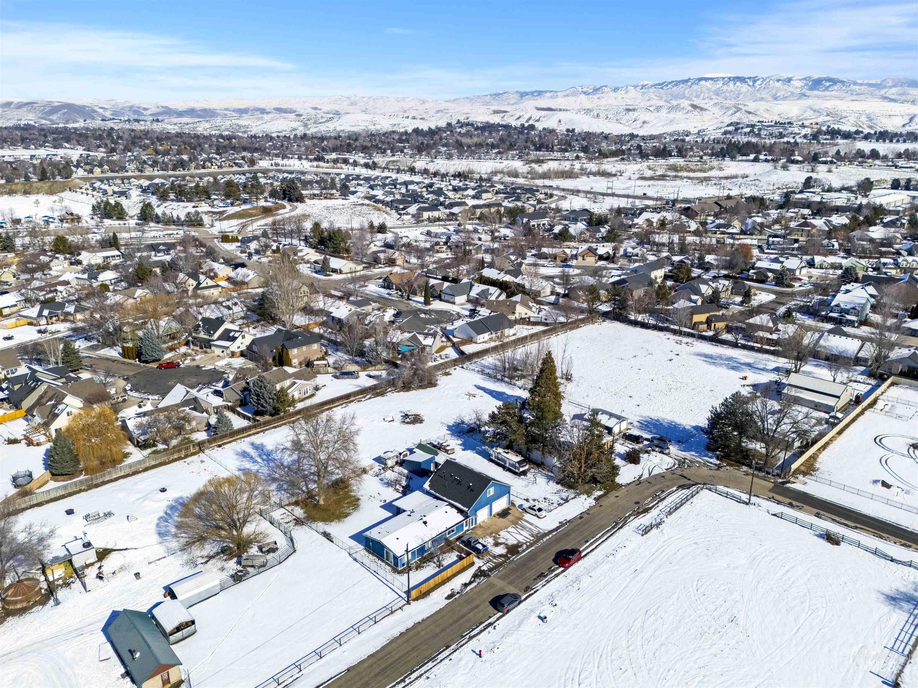 2382 East Syringa Street Eagle, ID 83616 - Photo 6 of 25 Snowy aerial view featuring a residential view and a mountain view
