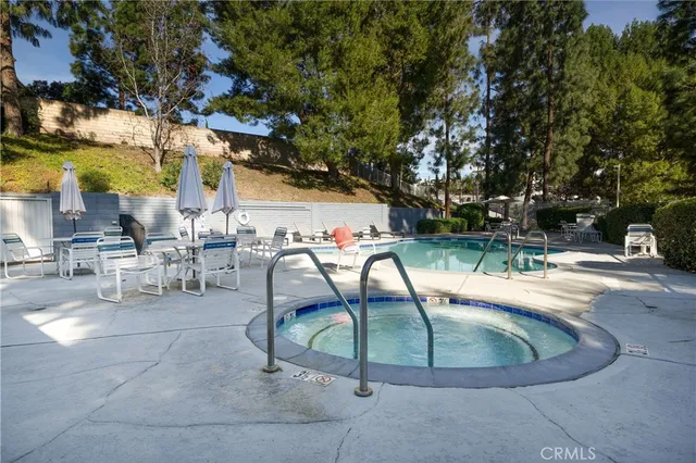 an aerial view of a houses with a swimming pool