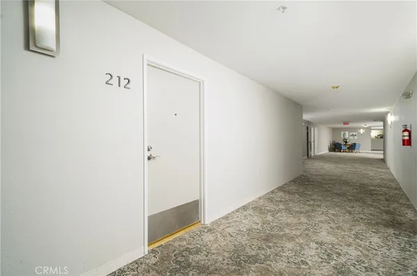 a view of a kitchen with a sink and a refrigerator