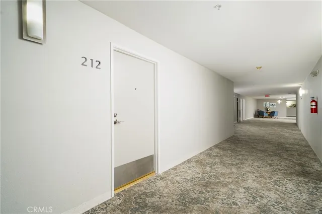 a view of a kitchen with a sink and a refrigerator