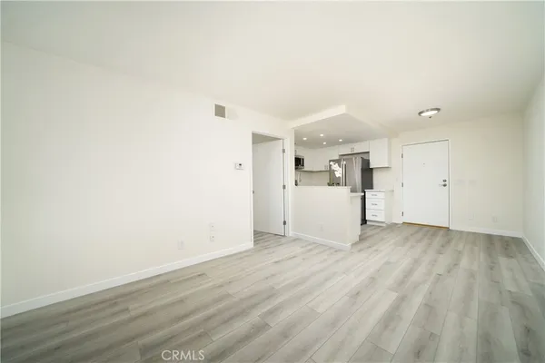 a kitchen with a refrigerator a sink and a stove top oven