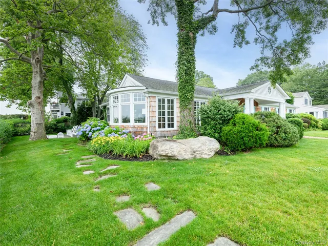 a view of a house with a yard and porch