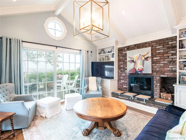 a living room with fireplace furniture and a flat screen tv