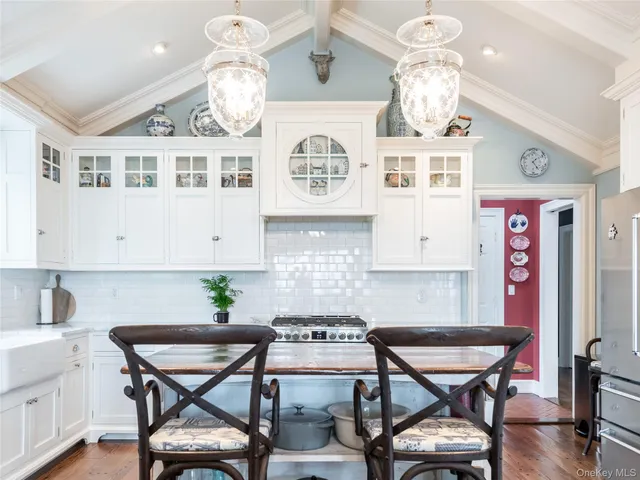 a kitchen with stainless steel appliances kitchen island a table and chairs in it
