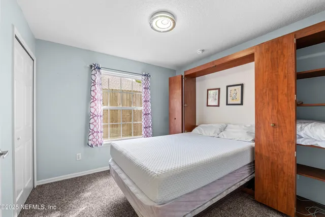 a dining room with furniture a chandelier and wooden floor