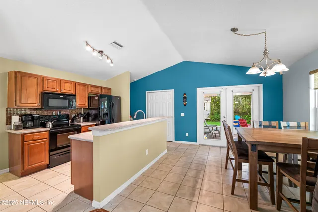 a kitchen with granite countertop a sink and refrigerator