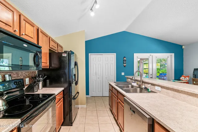 a view of a living room with furniture and a large window