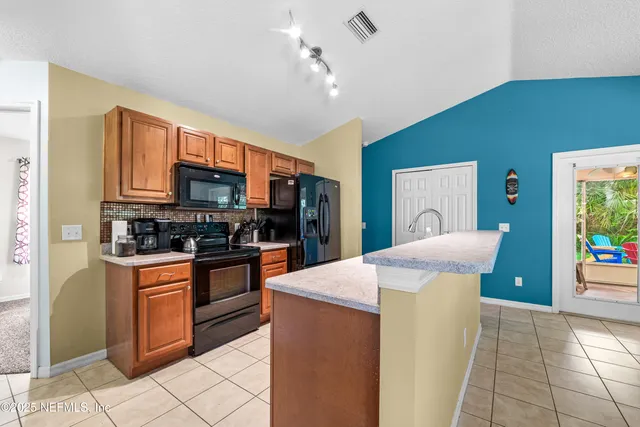 a living room with furniture a window and wooden floor