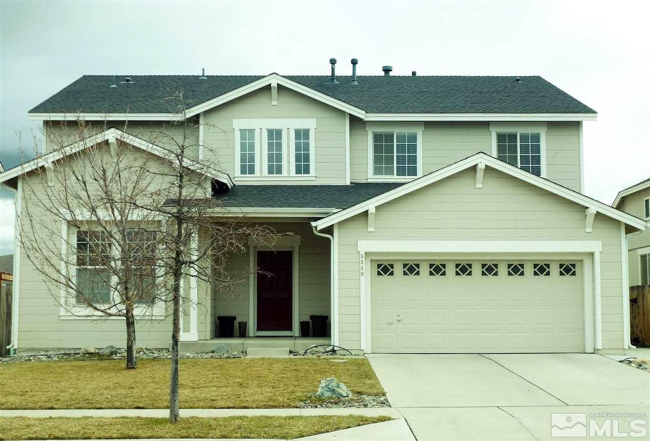 8940 Mahon Drive Reno, NV 89506 - Photo 1 of 1 a view of a white house with large windows and a small yard