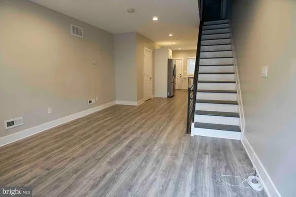 an empty room with wooden floor