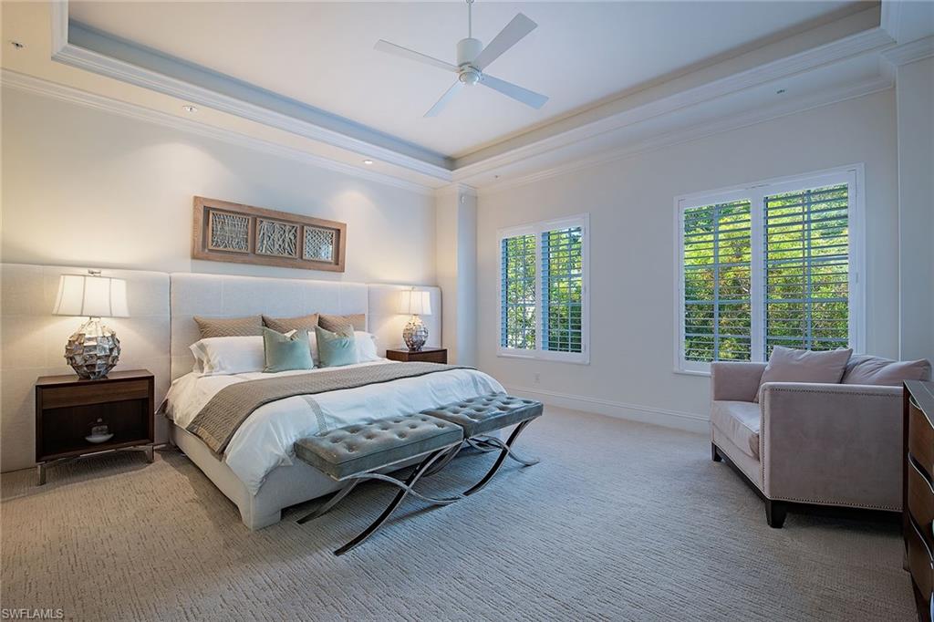 750 11th Street South, Unit C Naples, FL 34102 - Photo 12 of 25 a spacious bedroom with a bed and a couch