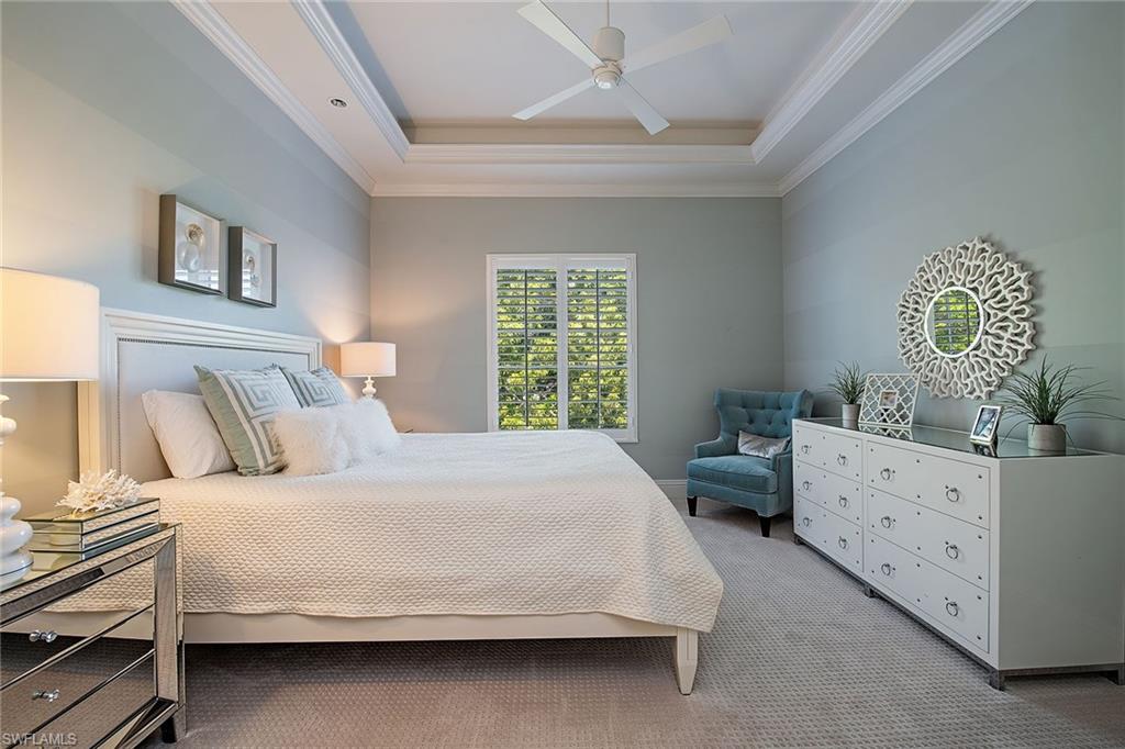 750 11th Street South, Unit C Naples, FL 34102 - Photo 16 of 25 a bedroom with a bed and a dresser