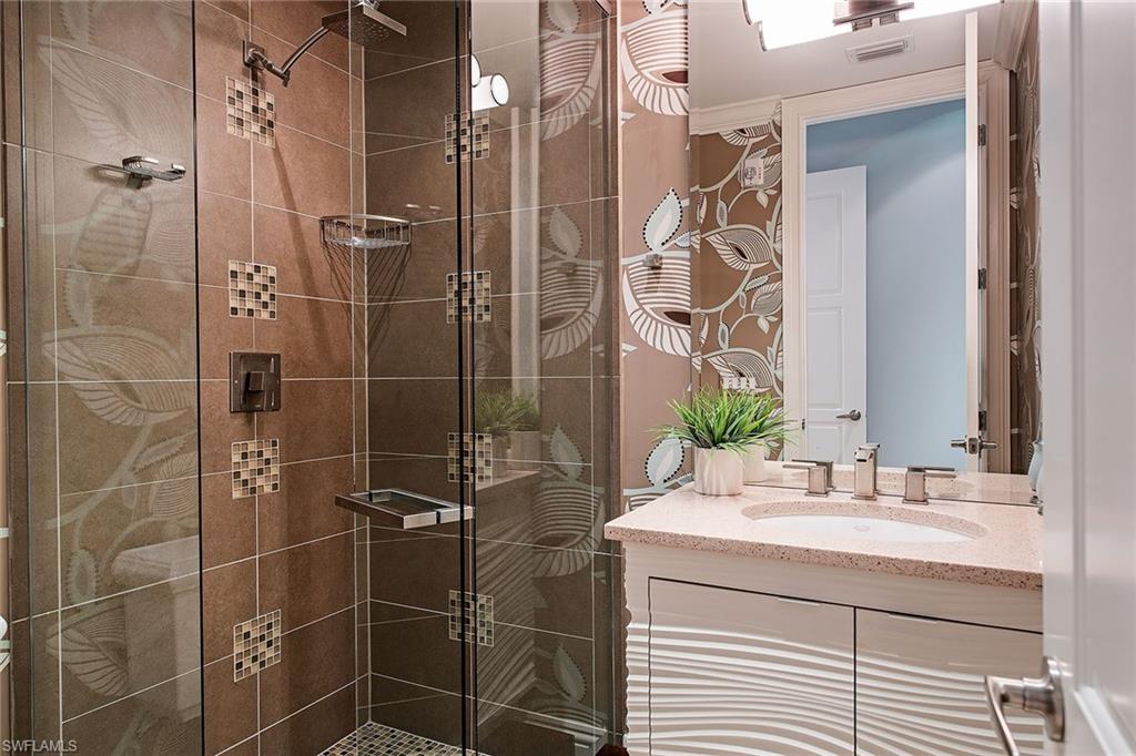 750 11th Street South, Unit C Naples, FL 34102 - Photo 17 of 25 a bathroom with a sink shower and a mirror