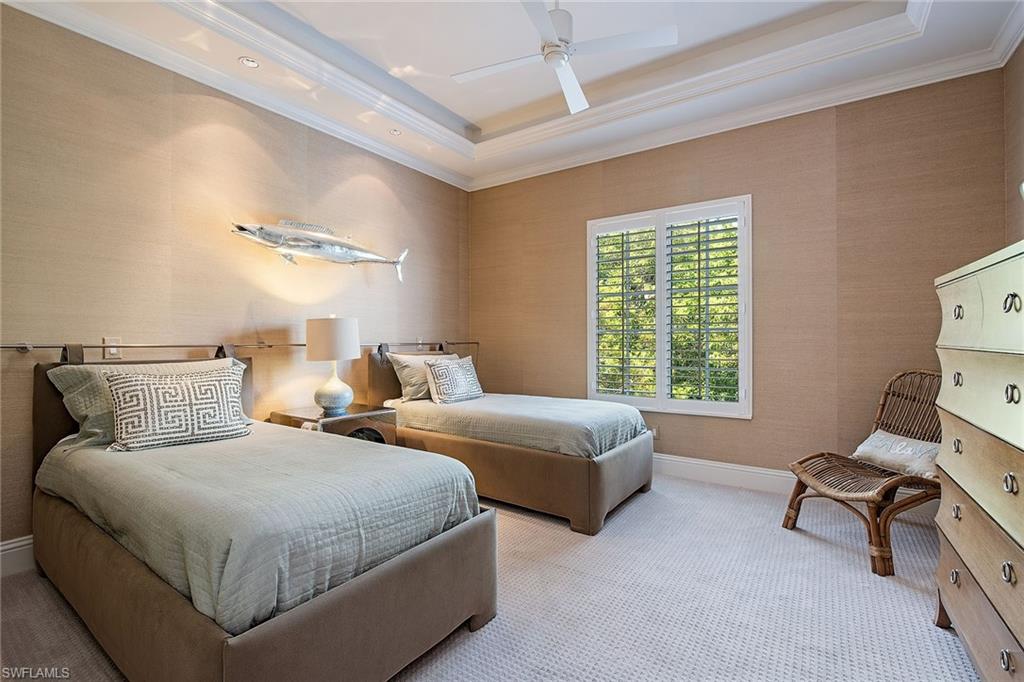 750 11th Street South, Unit C Naples, FL 34102 - Photo 18 of 25 a bedroom with two beds and a couch