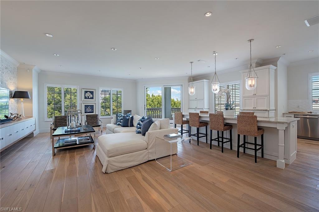 750 11th Street South, Unit C Naples, FL 34102 - Photo 2 of 25 a living room with furniture and wooden floor