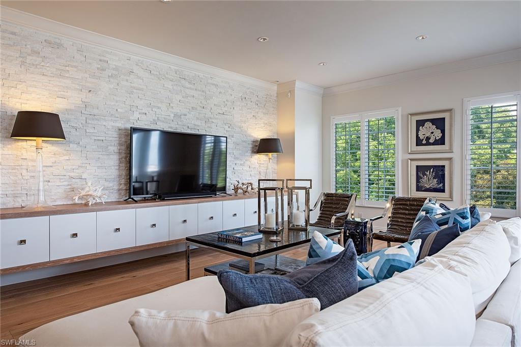 750 11th Street South, Unit C Naples, FL 34102 - Photo 3 of 25 a living room with furniture and a flat screen tv