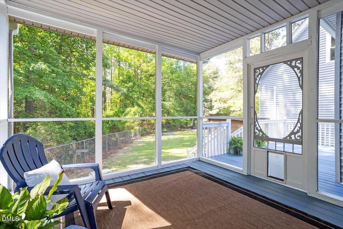 7505 Penny Road Raleigh, NC 27606 - Photo 7 of 35 a view of a porch with chairs and backyard