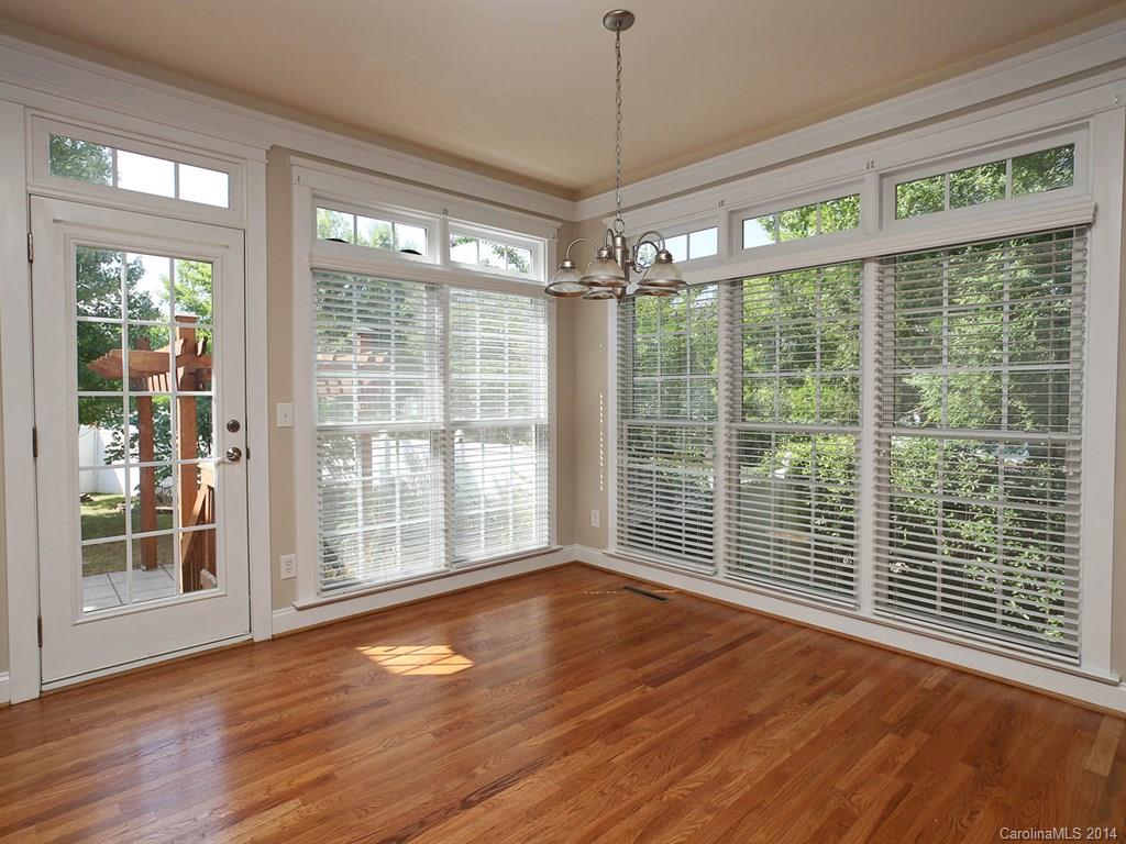 329 Third Baxter Street Fort Mill, SC 29708 - Photo 14 of 23 a view of empty room with wooden floor and floor to ceiling window