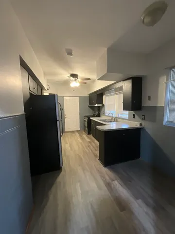 a kitchen with kitchen island a sink a counter top space and stainless steel appliances