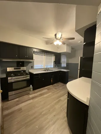 a kitchen with a sink and a stove top oven