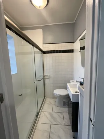 a bathroom with a toilet a sink and shower