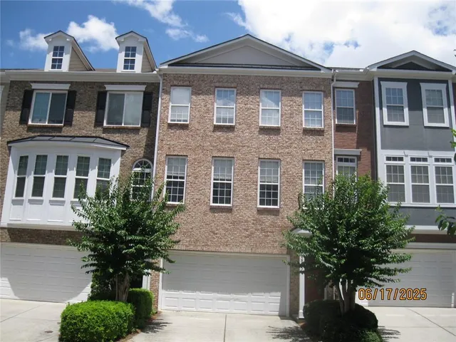 a front view of a house with lots of trees