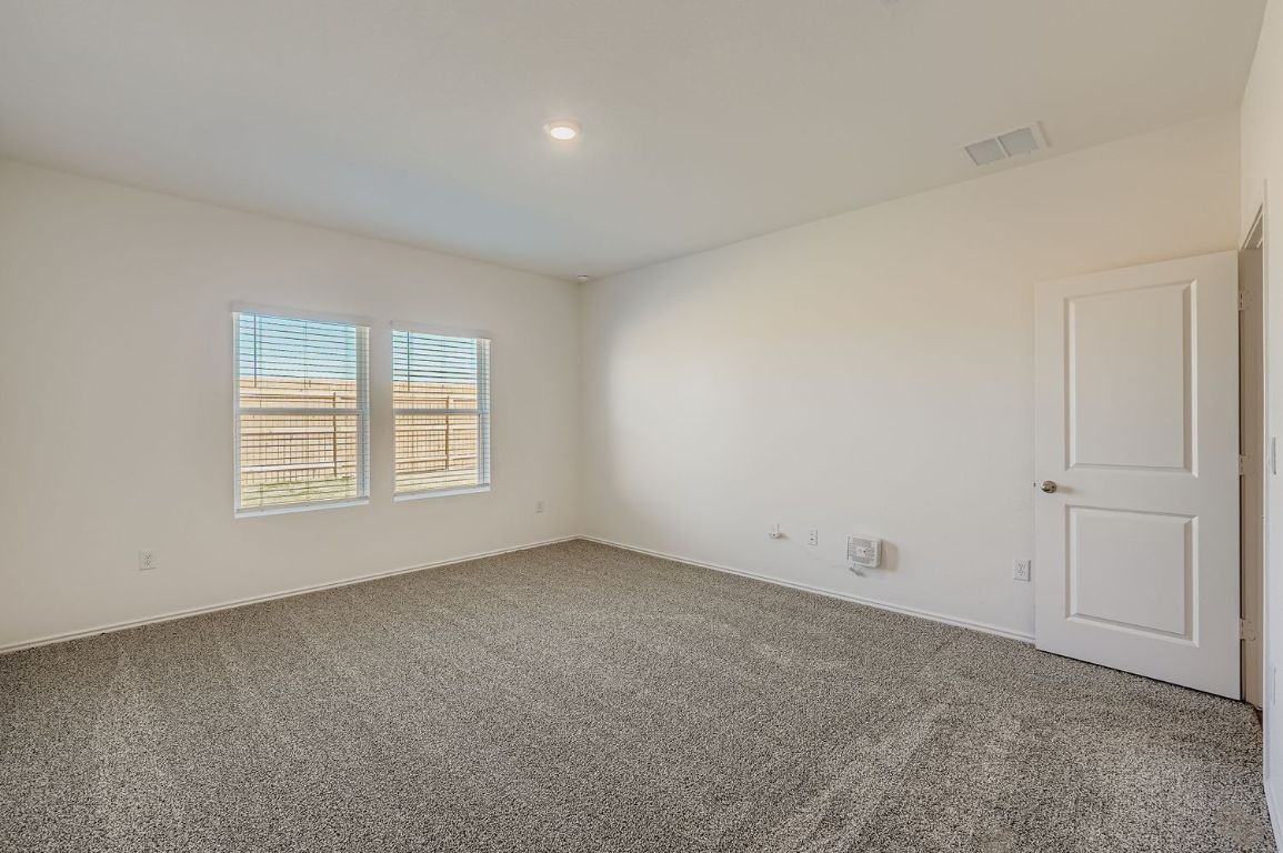 12112 Douglas Fir Circle Mustang Ridge, TX 78610 - Photo 18 of 33 a view of an empty room with a window