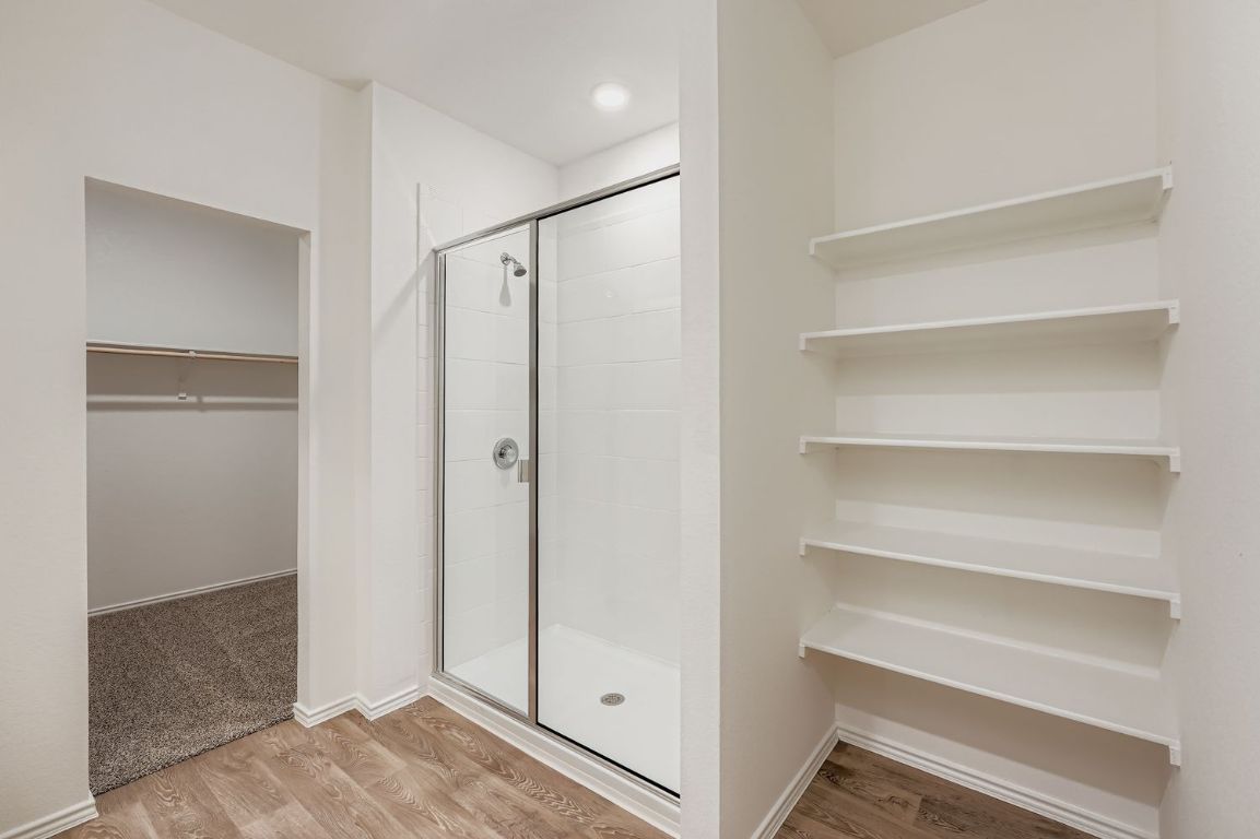 12112 Douglas Fir Circle Mustang Ridge, TX 78610 - Photo 22 of 33 a view of walk in closet with empty racks